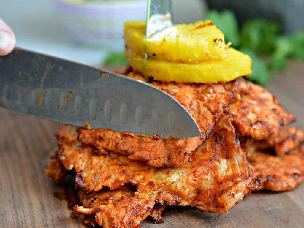 Tacos al Pastor - made with slow marinated pork, grilled to perfection, and served with grilled pineapple.