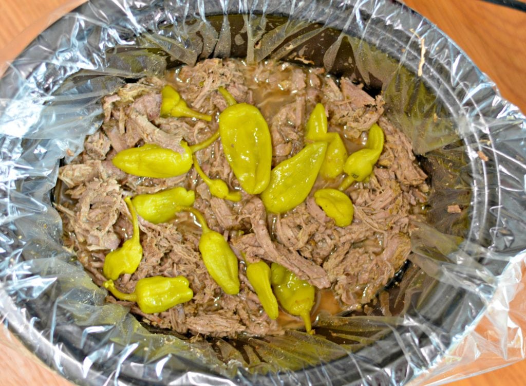 Slow Cooker Italian Beef Sandwich recipe with slow cooked, tender beef, delicious golden Mezzetta peperoncini, and soft bread. 