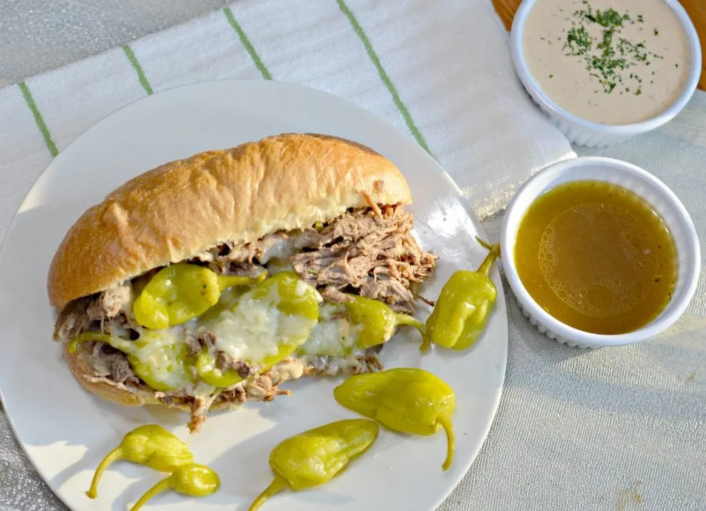 Slow Cooker Italian Beef Sandwich recipe with slow cooked, tender beef, delicious golden Mezzetta peperoncini, and soft bread. 