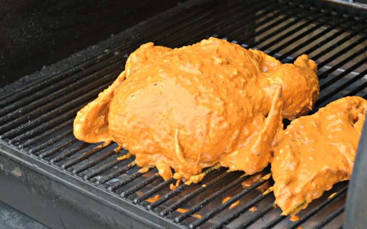 Whole chicken with marinate on a wood pellet grill