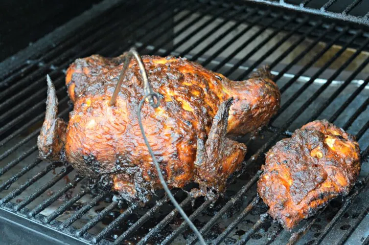 Smoked Whole Chicken on a wood pellet smoker ready to pull off