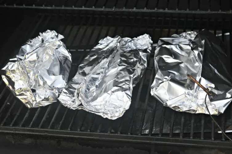 Salmon in foil on grill cooking