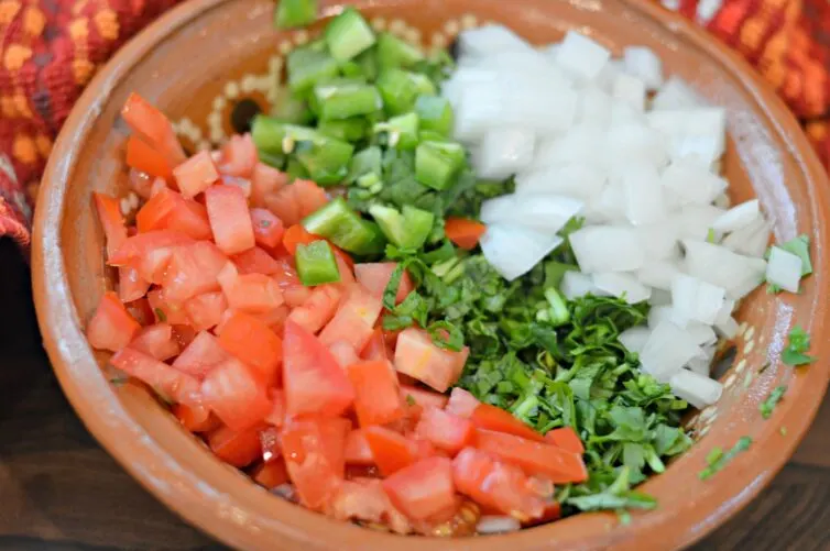 tomato, onion, jalapenos, cebolla and cilantro in a bowl