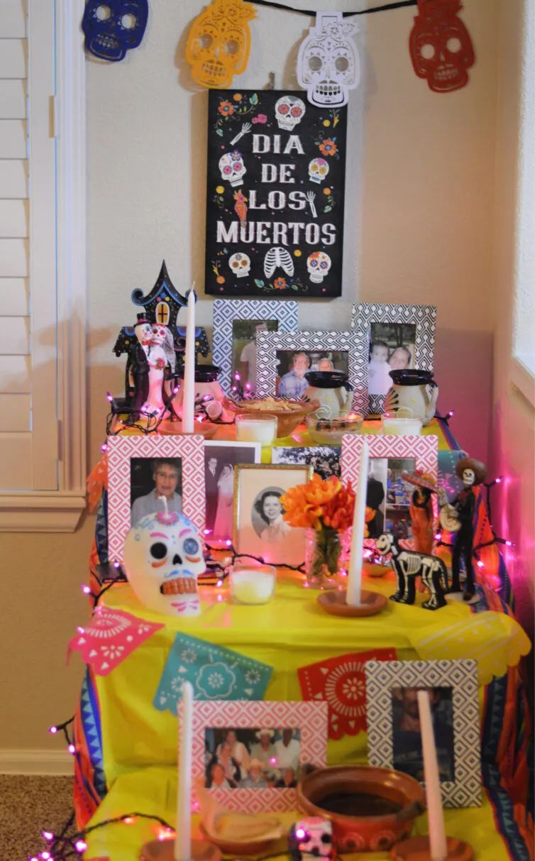 day of the dead altar with pictures and food