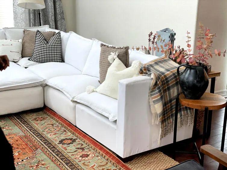 white furniture in the great room with rug
