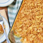 Cheesy funeral potatoes with a buttery corn flake topping