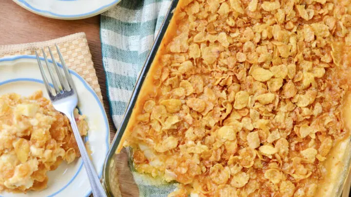 Cheesy funeral potatoes with a buttery corn flake topping