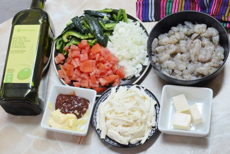 ingredients for shrimp tacos like shrimp, tomatoes, cheese, chipotle, butter, and oil