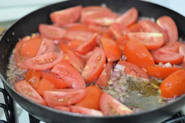 tomatoes cooking with the other ingredients in a large skillet