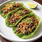 Lettuce Wraps with ground beef one a plate with a lemon wedge